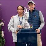 Fans posing with the Claret Jug in Champions Suite at The Open