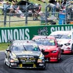 Supercars in racing formation up Mount Panorama during Bathurst 1000