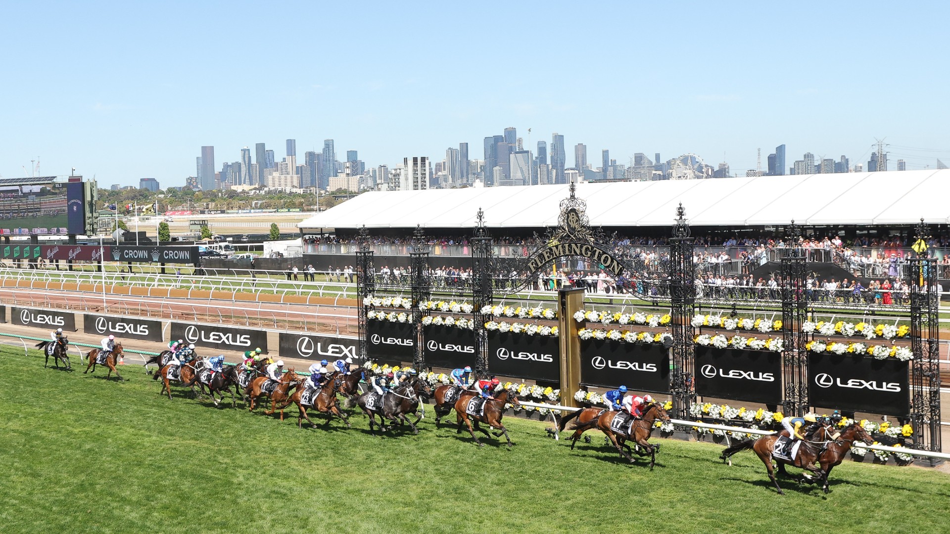 Horses racing past the Winning Post at Flemington Racecourse