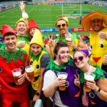A ground of friends dressed up, enjoying a drink in the South Stand
