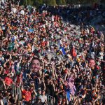 Close up of the atmosphere and crowds with cut-out of Daniel Ricciardo