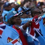 Fiji fans with Fijian kit and the Fijian flag