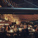 Night shot of Bennelong Restaurant in the Sydney Opera House with patrons dining