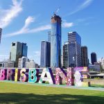 Welcome to Brisbane sign with city skyline in the background