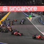 Cars jostle for position at the first turn of the Marina Bay Street Circuit